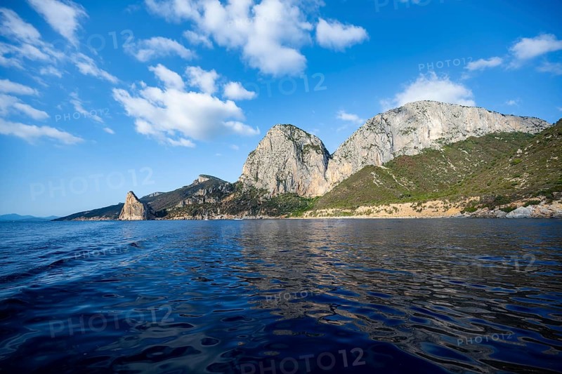 Picturesque rocky coast, cliffs with Pedra Longa pinnacle, blue sea, Golfo di Orosei, Baunei, Sardinia, Italy