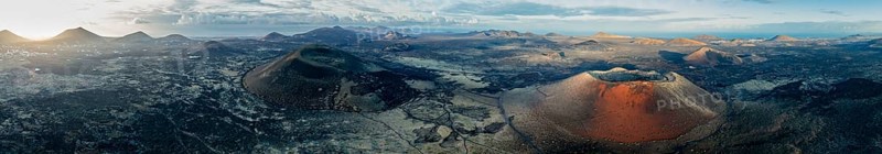 Panorama, Caldera Colorada volcano and MontaÃ±a Negra, picturesque volcanic landscape with volcanic craters at sunrise, Parque Natural de Los Volcanes, aerial view, Lanzarote, Canary Islands, Spain
