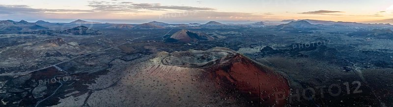 Caldera Colorada volcano, picturesque volcanic landscape with volcanic craters at sunrise, Los Volcanes Natural Park, aerial view, Lanzarote, Canary Islands, Spain