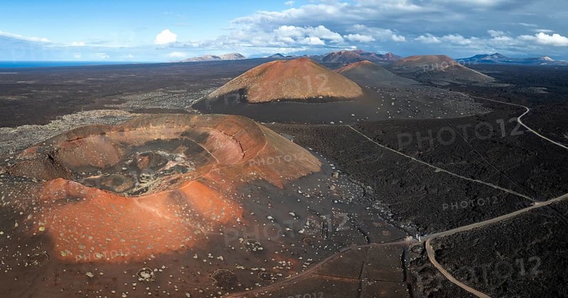 MontaÃ±a Quemada and MontaÃ±a Pedro Perico volcanoes, volcanic landscape with craters and lava fields, aerial view, Lanzarote, Canary Islands, Spain