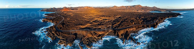 Coast with lava fields, volcanic landscape near Los Hervideros with red volcano MontaÃ±a Bermeja, in the evening light, aerial view, Lanzarote, Canary Islands, Spain