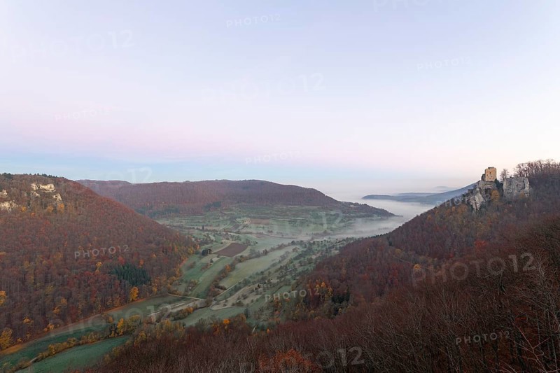 Sunrise with fog in the Neidlinger Valley with a view of the Reussenstein castle ruins. Swabian Jura, Baden-WÃ¼rttemberg, Germany