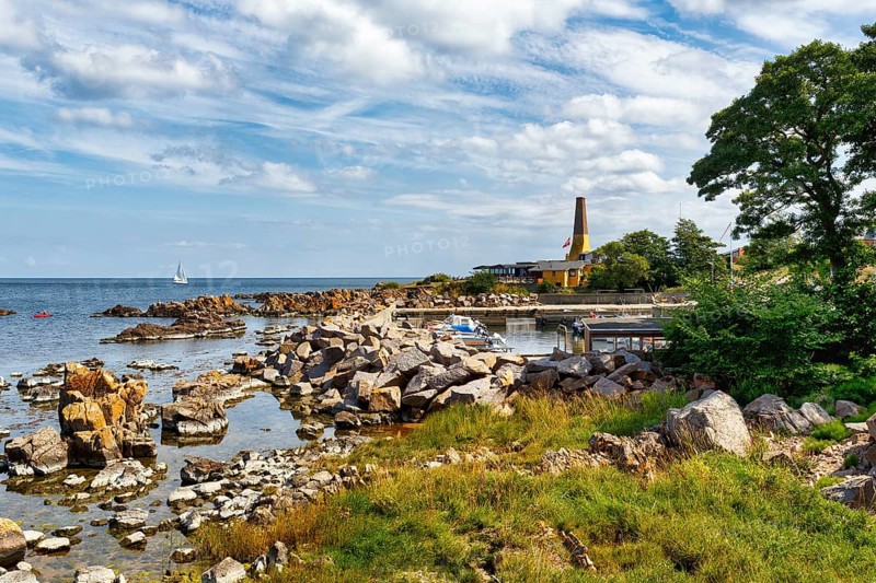 Coastline with granite rocks and sailboat, Hammerknuden, Allinge, Bornholm, Denmark