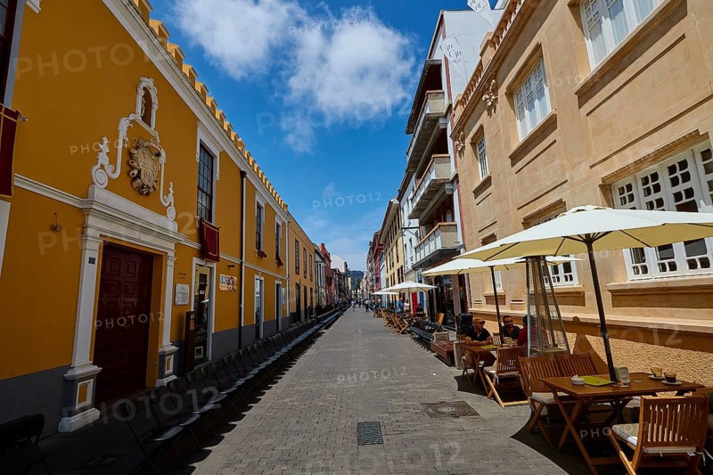 Bustling old town street with cafés and yellow buildings, UNESCO World Heritage Old Town of San Crstobal de La Laguna, La Laguna, Tenerife, Canary Islands, Spain
