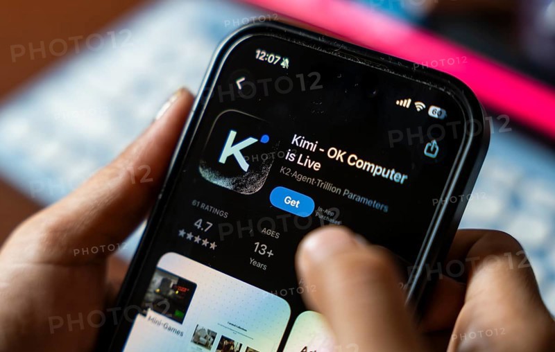 In this photo illustration, a person uses the Kimi AI chatbot on a smartphone, in New Delhi, India on 20 November 2025. Kimi AI is a Chinese artificial intelligence chatbot and assistant developed by Moonshot AI, a fast-growing tech company in China
