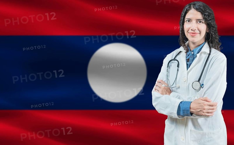 Laotian medicine and healthcare concept Doctor close up against Laos flag background