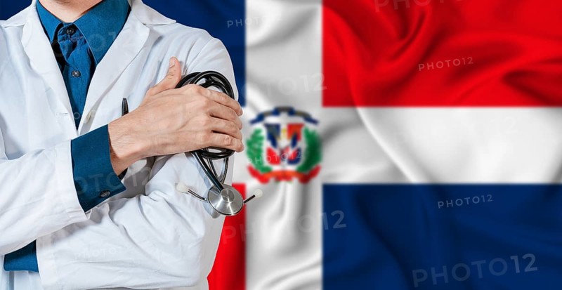 Dominican Republic healthcare concept. Doctor with stethoscope on Dominican Republic flag. Doctor holding stethoscope on Dominican flag