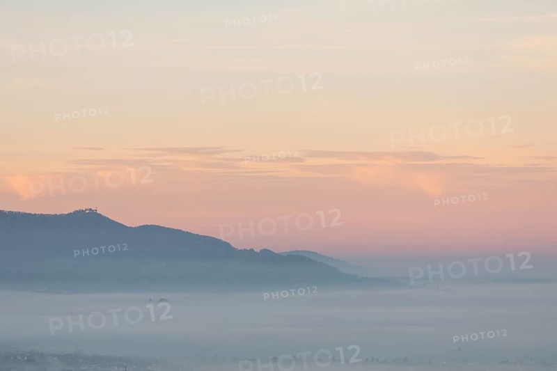 The majestic Teck Castle towers over the fog in the foothills of Alb. Aichelberg View of Teck Castle in a sea of fog