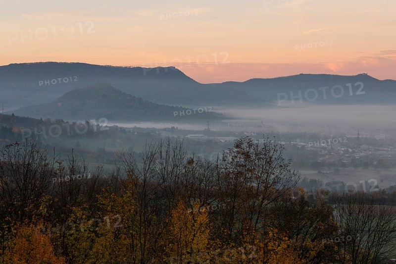 The majestic Teck Castle towers over the fog in the foothills of Alb. Aichelberg View of Teck Castle and Limburg in autumn
