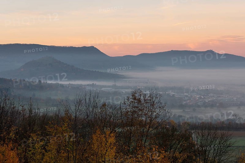The majestic Teck Castle towers over the fog in the foothills of Alb. Aichelberg View of Teck Castle and Limburg in a sea of fog