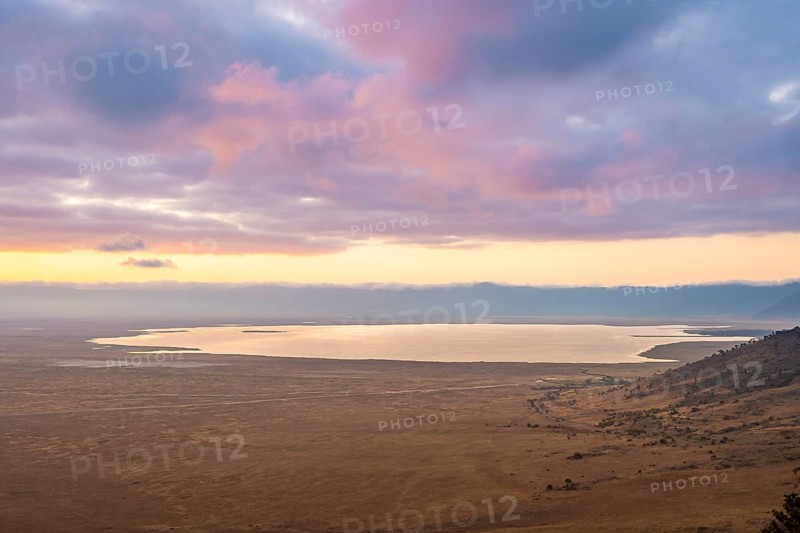 View of savanna landscape and Magadi Lake at sunrise, atmospheric morning light, view of Ngorongoro Crater, Ngorongoro Conservation Area, Tanzania