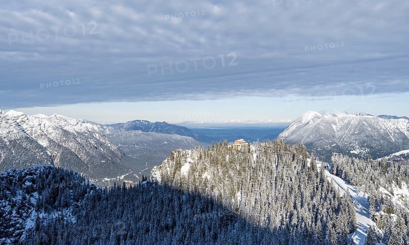 Snowy forest and Kreuzeckhaus mountain hut in the Garmisch Classic ski area in winter, Wetterstein Mountains, Garmisch-Partenkirchen, Bavaria, Germany