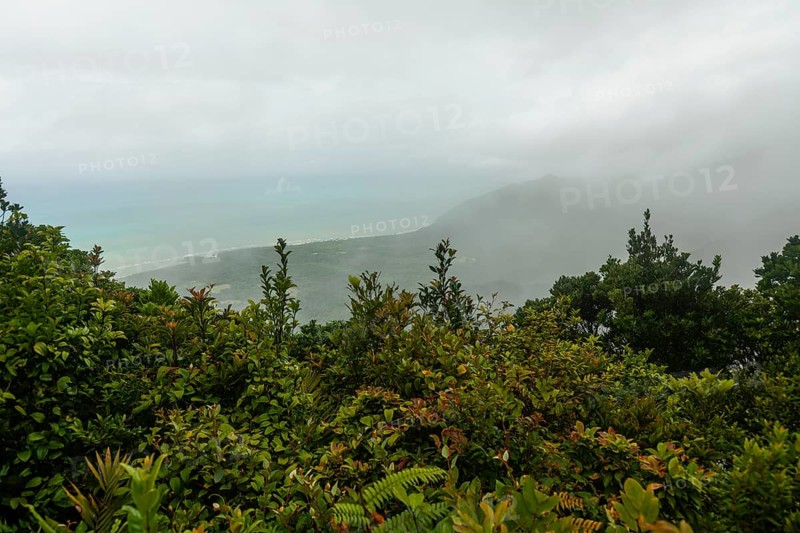 Distant tropical view from Mount Sorrow across valley and bay to where the Great Barrier Reef meets the coast Queensland, Australia