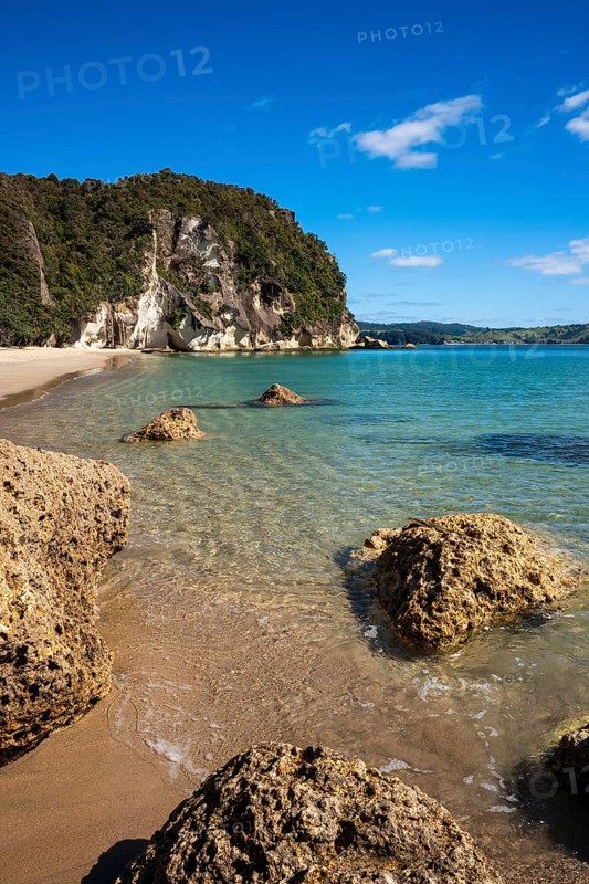 Landscape with sea, rocks and sandy beach in New Zealand. Lonely Bay, Shakespeare Cliff in the back, Cooks Beach, Coromandel Peninsula, Waikato, New Zealand