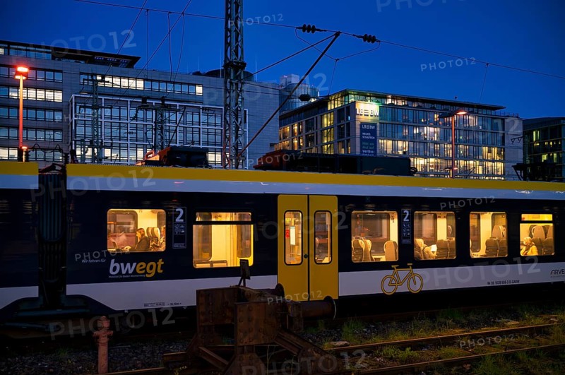 Incoming train, regional express, RE, bwegt, with bicycle compartment, in the background BW Bank, Baden-Wuerttembergische Bank, central railway station, blaue Stunde, Stuttgart, Baden-WÃ¼rttemberg, Germany