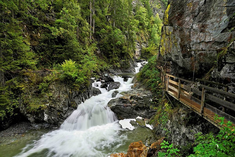 Wooden walkway next to the Diosaz mountain river in the gorge, Gorges de la Diosaz, Les Houches, Chamonix-Mont-Blanc, Haute-Savoie, France