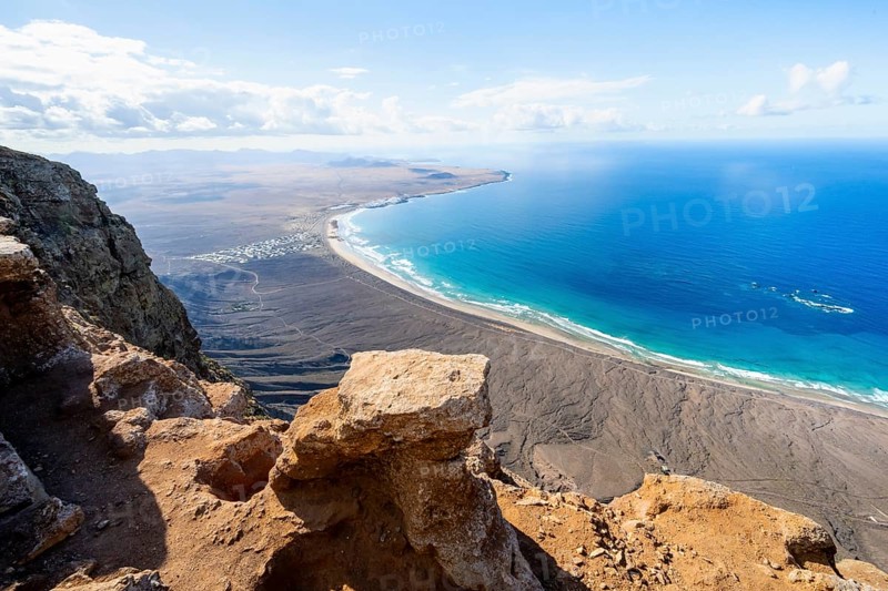 View from the Risco de Famara Cliff to Famara Beach, Playa de Famara with La Calaeta, Lanzarote, Canary Islands, Spain