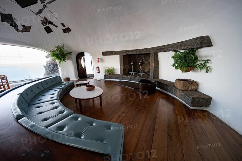 Sitting area with large sofa and fireplace, interior at the Mirador del RÃ­o viewpoint, designed by artist César Manrique, Lanzarote, Canary Islands, Spain