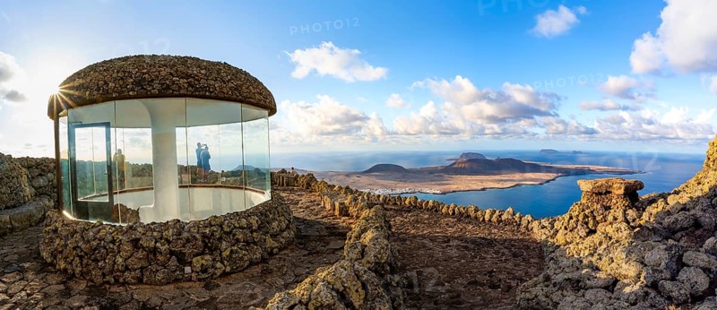 Stairway and viewing platform at the Mirador del RÃ­o viewpoint, in the evening light with sun stars, designed by artist César Manrique, view of the island of La Graciosa, Lanzarote, Canary Islands, Spain