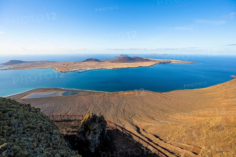 View of La Graciosa island with volcanic craters in the evening light, Mirador del RÃ­o viewpoint designed by artist CÃ©sar Manrique, Lanzarote, Canary Islands, Spain