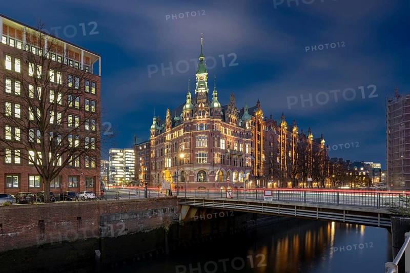 Speicherstadtrathaus am St. Annenfleet in the Speicherstadt Hamburg during blue hour with traces of vehicles in the foreground, Hamburg, Germany
