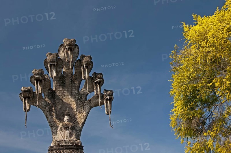 Monumental depiction of Buddha meditating under the protection of a seven-headed naga snake, Wat Khaek, also Sala Kaew Ku sculpture park, Nong Khai, Thailand