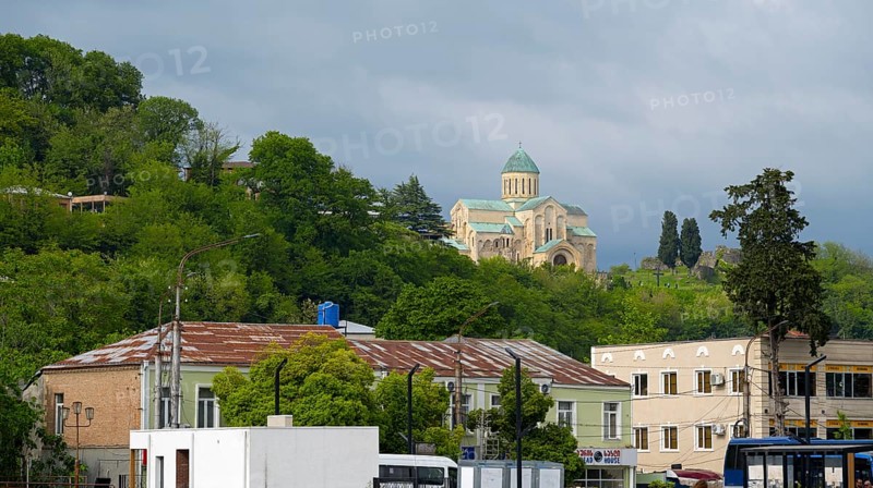 Church on a green hill above city buildings in the foreground, Bagrati Cathedral, Church of the Dormition of the Most Holy Mother of God, UNESCO World Heritage Site, Kutaisi, Imereti Region, Georgia
