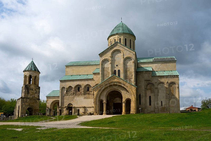 Large historic church surrounded by greenery under a cloudy sky, Bagrati Cathedral, Church of the Dormition of the Most Holy Mother of God, UNESCO World Heritage Site, Kutaisi, Imereti Region, Georgia
