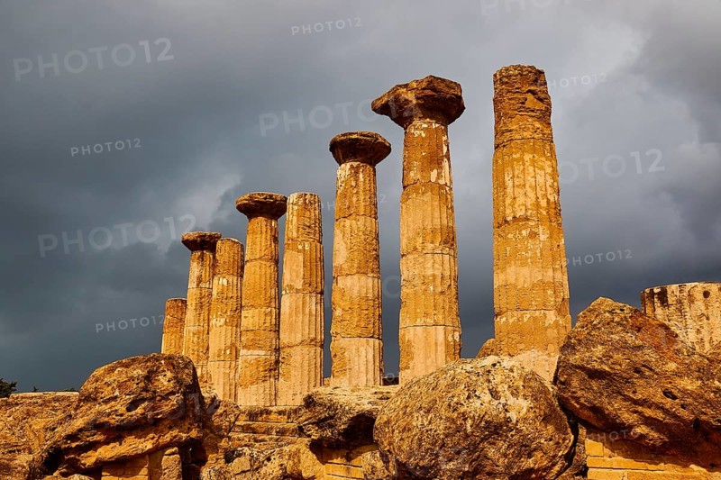 Temple of Heracles, ancient columns under dramatic stormy sky, Valley of the Temples, Valle dei Templi, Archaeological Site, UNESCO World Heritage Site, Agrigento, Sicily, Italy
