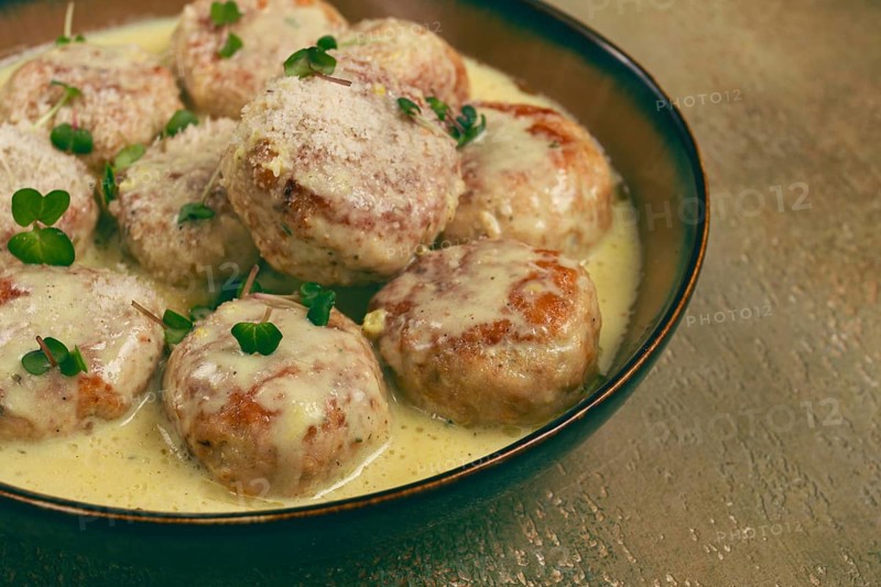 Chicken meatballs, in cream sauce, garnished with parmesan cheese, and microgreens, homemade, no people
