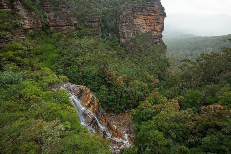 Leura Falls from above, in a lush valley full of ferns and vegetation, Blue Mountains, New South Wales, Australia