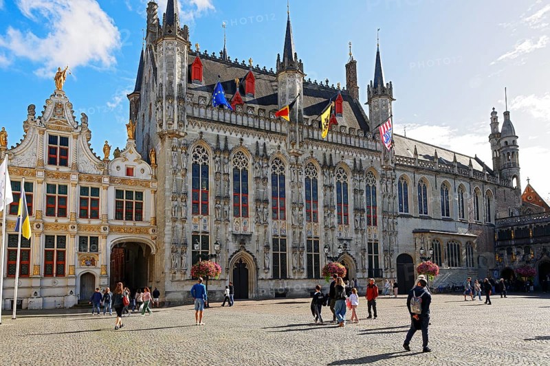 Historic Town Hall of Bruges on Castle Square, Stadhuis, (center of picture) as well as former court building today City Archive (left) and Basilica of the Holy Blood (right), Bruges, UNESCO World Heritage Site, Flanders, Belgium
