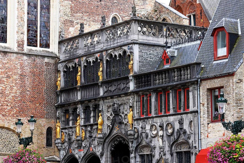 Richly decorated faÃ§ade and entrance portal with golden figures to the St. Ivo Chapel at the Basilica of the Holy Blood, Castle Square in the historic old town, Bruges, UNESCO World Heritage Site, Flanders, Belgium