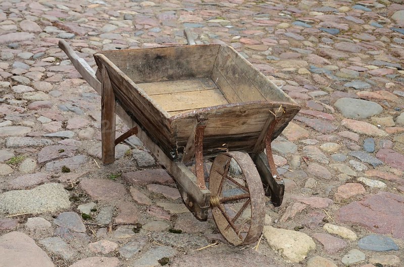 Old-fashioned wheelbarrow on paving stones in Den gamle by, The old village, open air museum in Odense, Fyn island, Fuen, Denmark, Scandinavia
