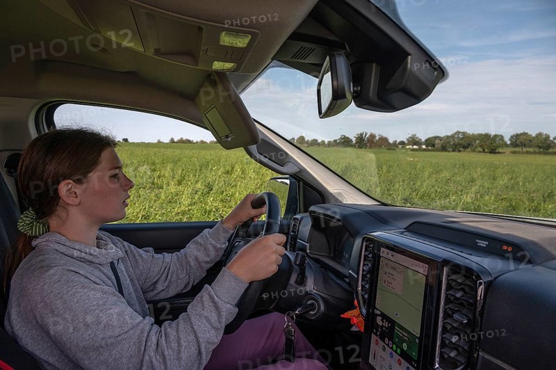 Young girl learns to drive a pickup truck on private property, Mecklenburg-Western Pomerania, Germany