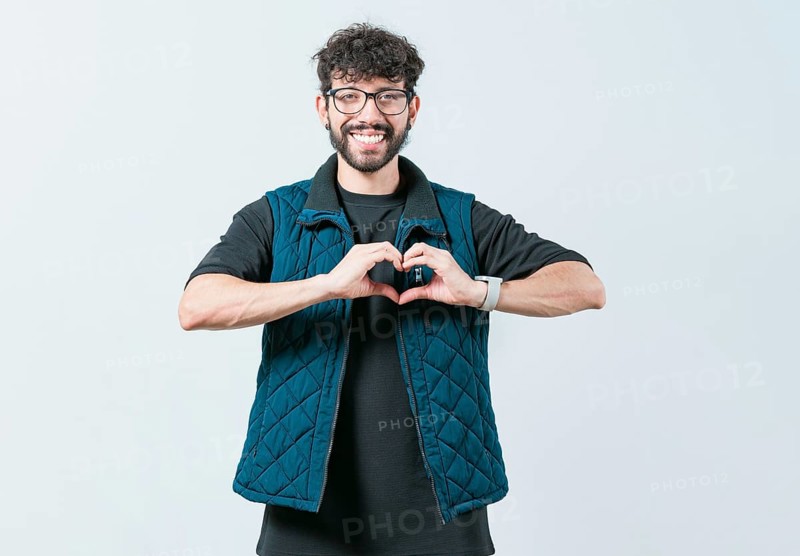 Funny man making heart shape isolated. Handsome guy making heart shape with hands