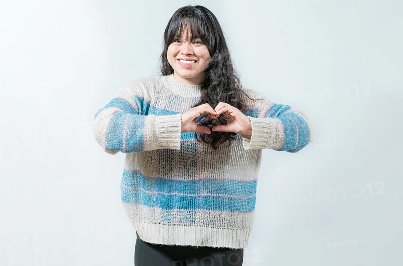 Beautiful asian girl making heart shape isolated. Happy asian woman making heart shape with hands