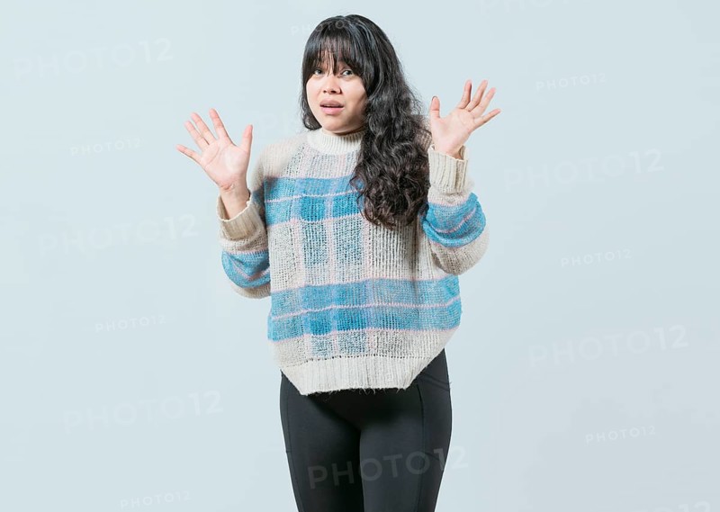 Scared asian woman with raised hands isolated. Young woman scared surprised with raised hands