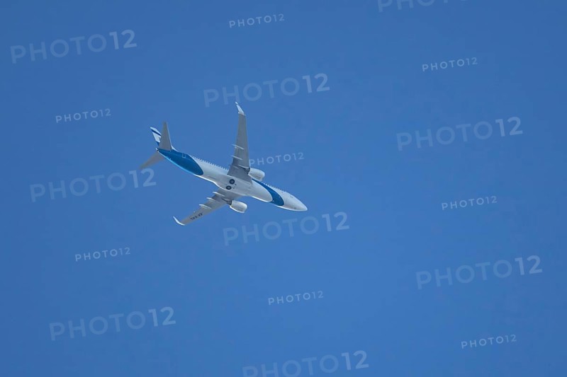 Boeing 737 jet passenger aircraft of El Al Israel airlines flying in a blue sky, England, United Kingdom