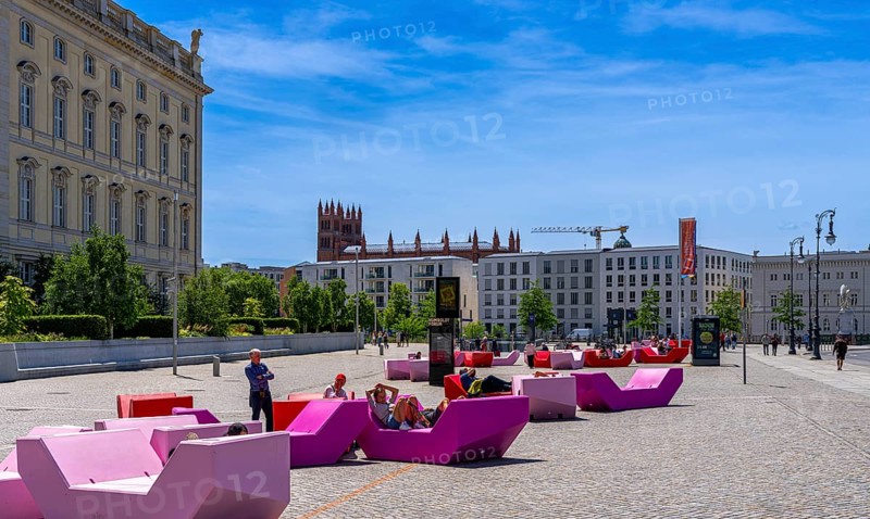 Colourful seating elements on the open space in front of the entrance to the Humboldt Forum, Berlin, Germany