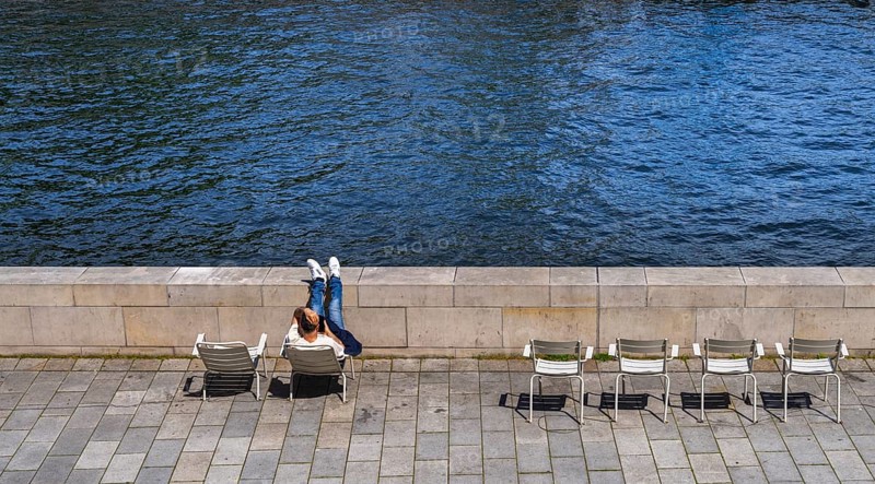 Promenade with chairs on the banks of the Spree from the Humboldt Forum, Berlin, Germany