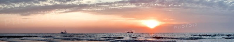 North Sea panorama crab fishermen in sunset mood