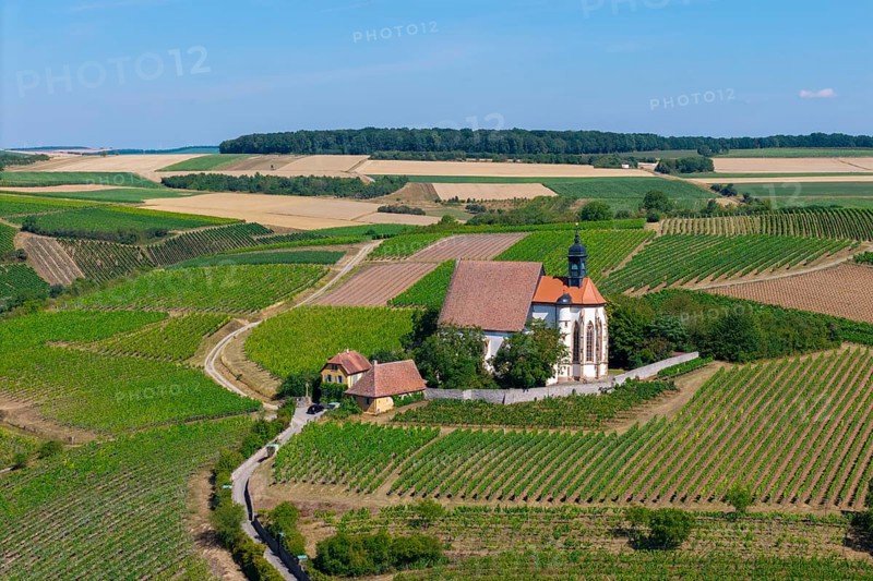 Pilgrimage church Maria im Weingarten, surrounded by green hills and fields under a sunny sky, aerial view, near Volkach am Main, Lower Franconia, Mainfranken, Bavaria, Germany