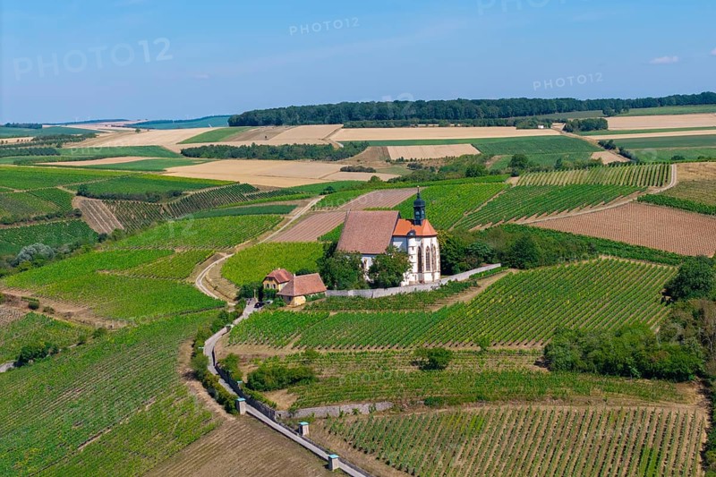 Pilgrimage church Maria im Weingarten, on a hill with surrounding fields under a blue sky, aerial view, near Volkach am Main, Lower Franconia, Mainfranken, Bavaria, Germany