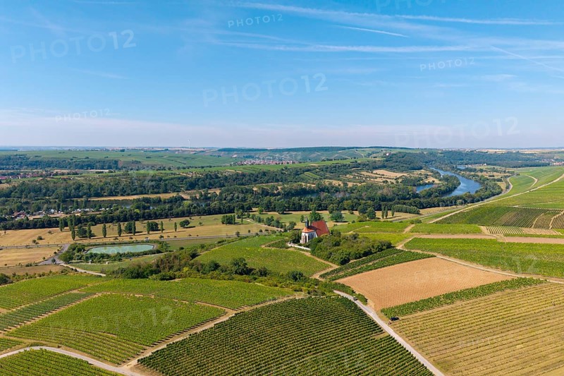 Pilgrimage church Maria im Weingarten, wide landscape view with vineyards, river and fields to the horizon under blue sky, aerial view, near Volkach am Main, Lower Franconia, Mainfranken, Bavaria, Germany