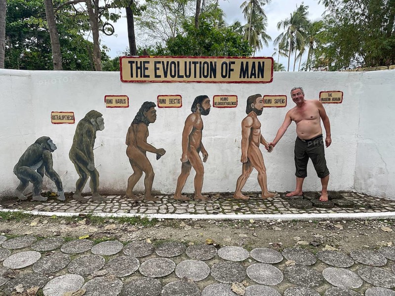 Evolution of anatomically modern man (Homo sapiens), parody, satire, funny, humour, shaking hands with the Neanderthal man, Negros, Philippines