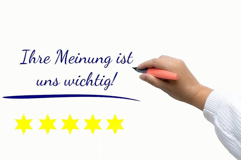 Rating Symbolic image: Text YOUR OPINION IS IMPORTANT TO US next to the cropped arm of a woman holding a writing instrument
