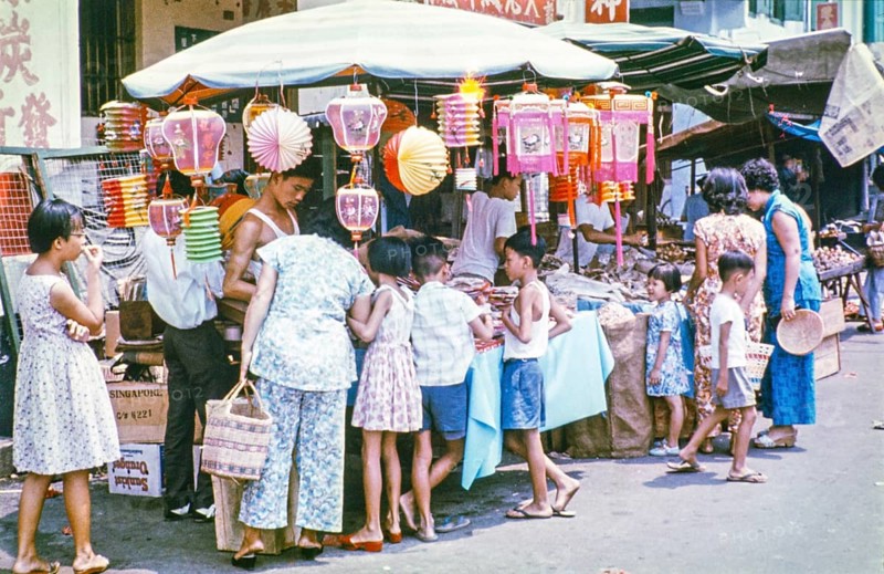 People at busy street market stall in Singapore, southeast Asia, c 1964