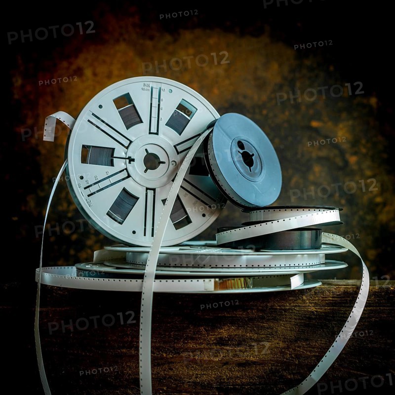 Old film strip reel showcasing vintage cinema history and its storytelling essence in a rustic environment