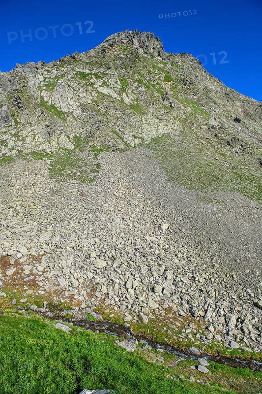 Smaller pieces of rock Rock stones lie eroded rock lies after landslide due to erosion on mountainside of rocky peak in Alps, Switzerland